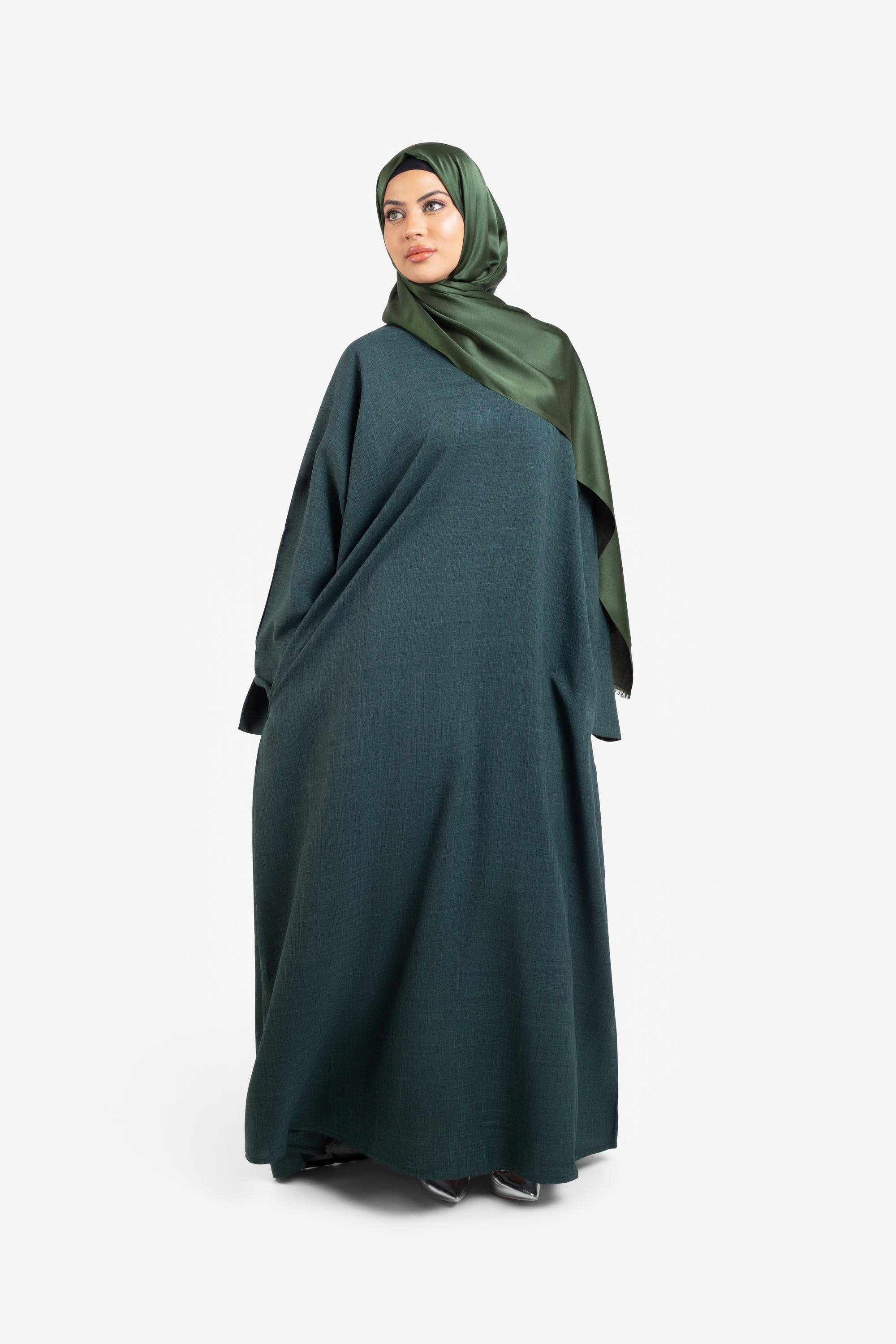 Plain linen dark green closed abaya with split cuffs front view